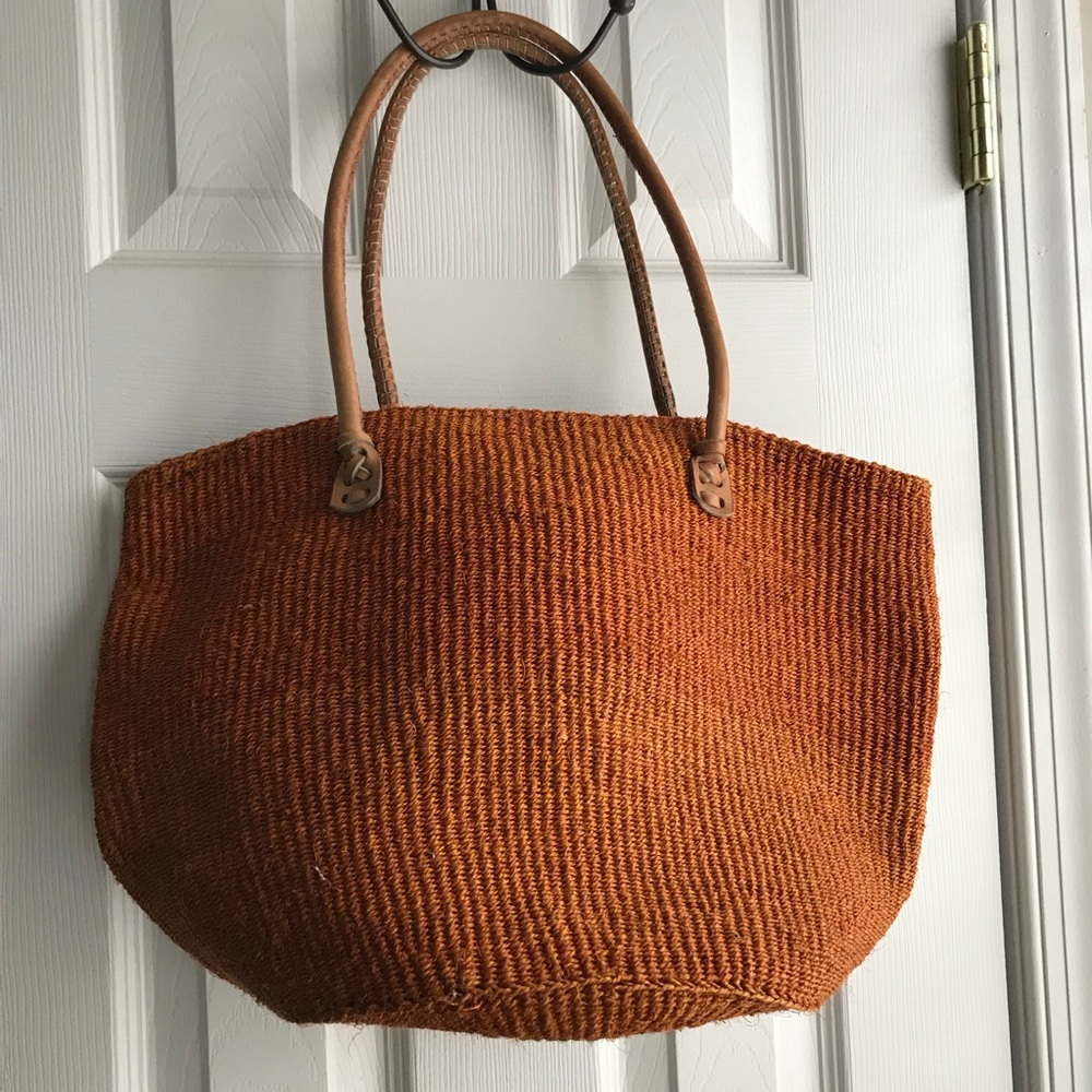 Orange straw tote with rolled leather handles